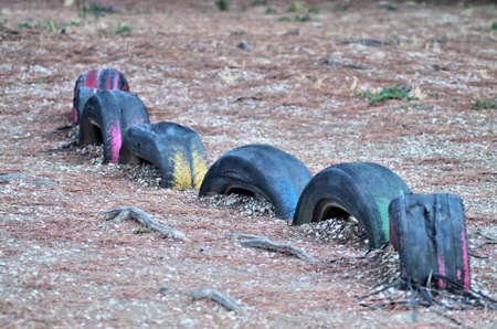 a bunch of colored tyres spreaded on the groundの写真素材