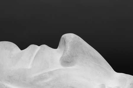This is not a work of art. The author does not need a release. This is an ordinary plaster head used for teaching students at the Institute of Photography. Shooting in the studio on black background, black and white still life abstraction.の写真素材