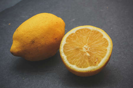 Food shot. Lemons Appetizing lemons, wooden board on a dark background.の写真素材