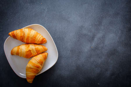 Delicious croissants on white square paper plate.の写真素材