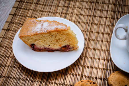 Large shot of sponge cake plum pie.freshly baked biscuit plum cake and a hot cup of tea