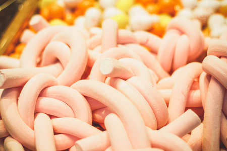 Pastry shop with wooden boxes filled to the top filled with sweets.Pink marshmallow made in the...