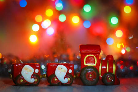 Happy New Year background for greeting card.  Toy Steam Train with Santa Claus on a background of...