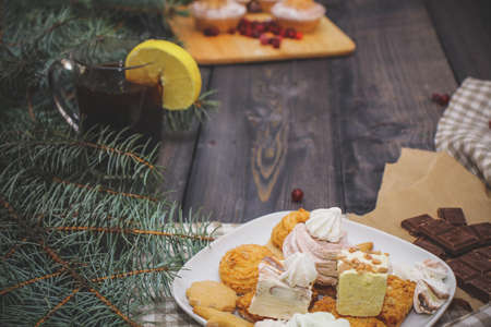 Happy New Year fir branches decorated with gingerbread stars, cinnamon sticks, dried orange slices...