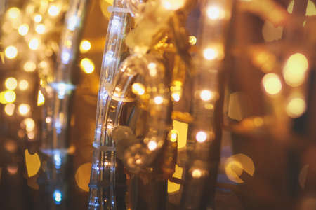 blur effect shooting bokeh on colored lights elimination in the park.festive illumination in the park bright yellow orange paint of lightの写真素材