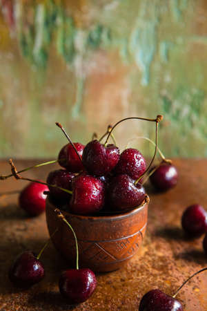 Fresh cherries in a ceramic cup. Close up. Copy space.