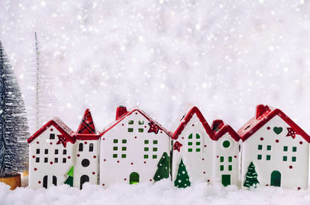 Christmas composition. Christmas trees and a Christmas houses in a snowy forest. Christmas, winter, new year concept. Close up, copy space.の写真素材