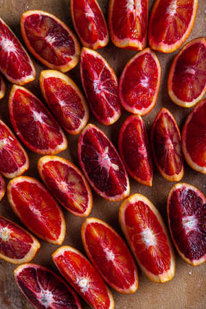 Slices of blood oranges on a beige background. Food background. Top view. Flat lay.の写真素材