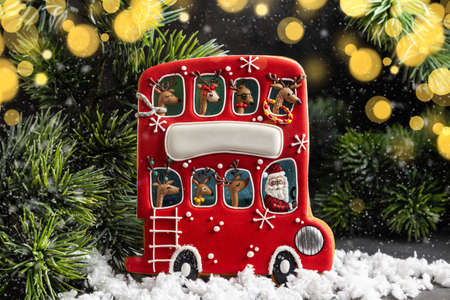 Homemade Gingerbread red Christmas bus with reindeer and Santa. Holiday card.の写真素材