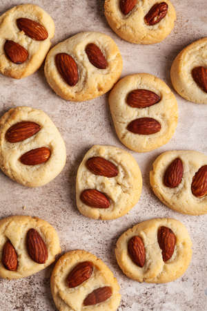 Cookies with almonds on a beige background.の写真素材