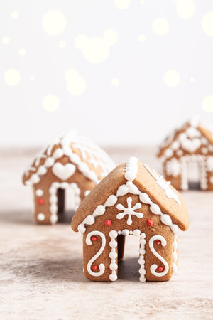 Three mini gingerbread houses on a beige background. Christmas concept.の写真素材