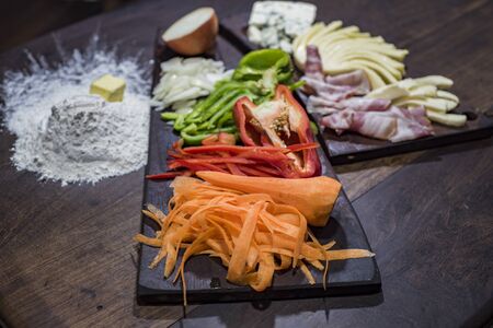 sliced vegetables and cold cuts for stuffed pizzaの写真素材