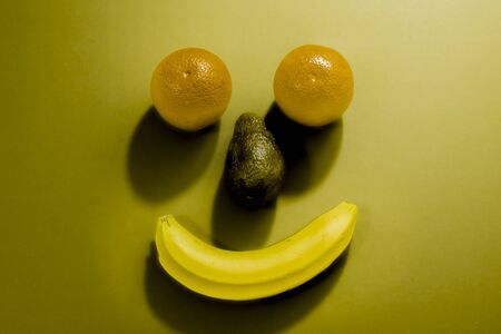 smiley face made with fruits on lightの写真素材