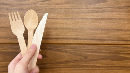 Eco-friendly disposable utensils made of wood with text space banner. Environmental protection, save nature, ecology plastic-free, zero waste concept. No pollution land by plastic.の写真素材