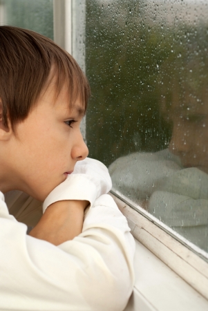 Peaceful boy sitting  at homeの写真素材