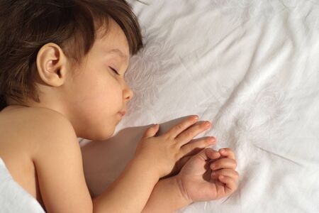 Small babylying on bed at home