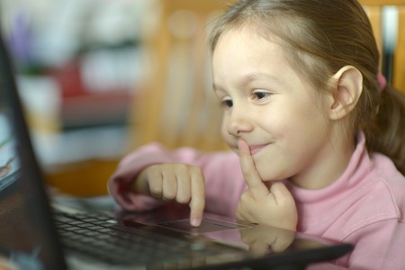 Close-up portrait of a little cute girl at homeの写真素材