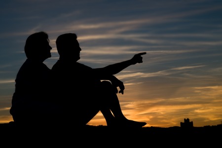 People silhouettes at sunset a clear summer nightの写真素材