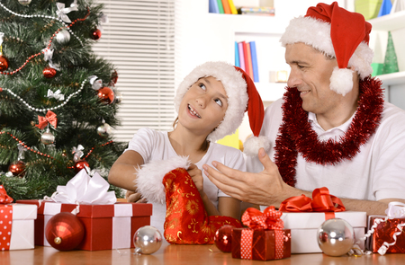 Happy father and son celebrating the New Year at homeの写真素材