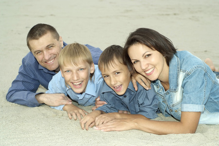 cheerful family of four on vacation in summerの写真素材