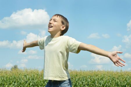 Portrait of a happy Boy in field enjoys natureの写真素材