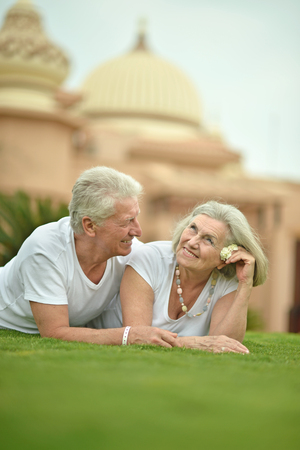 Senior couple lying at tropic hotel gardenの写真素材