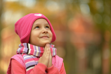 Cute little girl in an autumn parkの写真素材