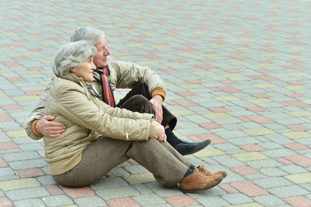 Senior couple in park ,sitting on floorの写真素材