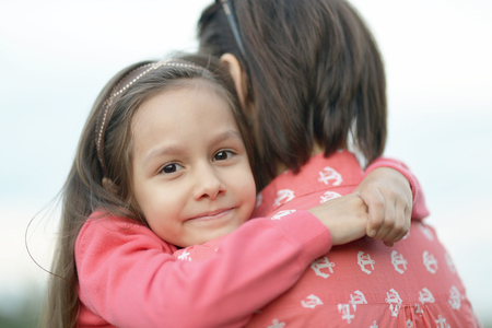 Little cute girl with her mother in parkの写真素材