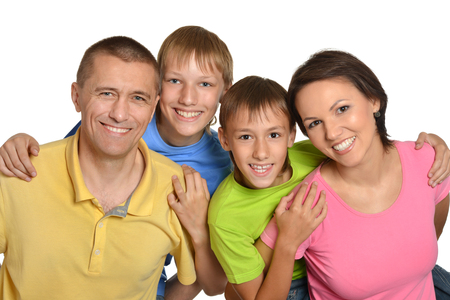 Cute family posing on a white backgroundの写真素材