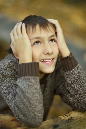 Portrait of happy boy in autumn parkの写真素材