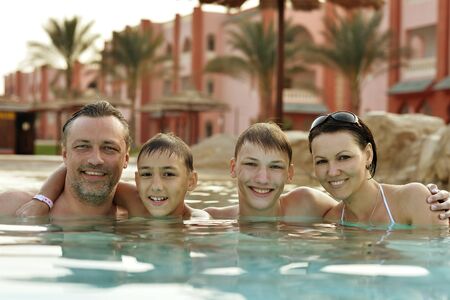 Portrait of a happy family relax in the poolの写真素材