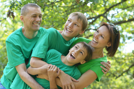 Happy Family resting in a summer parkの写真素材