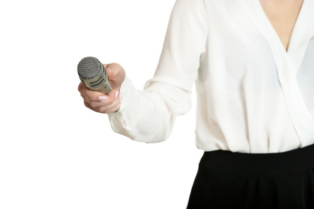 Happy young woman with microphone on white backgroundの写真素材