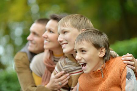 Portrait of family relaxing in autumn park