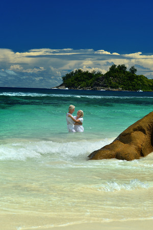 Loving elderly couple bathing in the sea and looking at each otherの写真素材