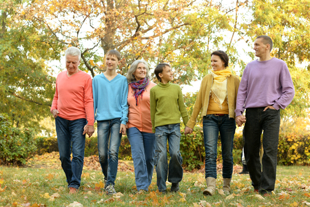 Happy smiling family relaxing in autumn parkの写真素材