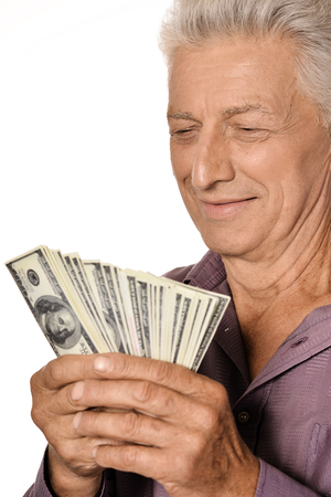 Elderly man holding dollars on white backgroundの写真素材