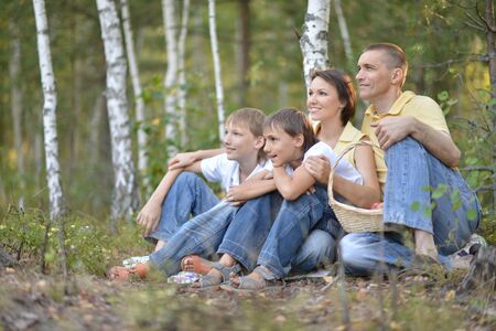 Beautiful happy family relaxing on the grass in the parkの写真素材