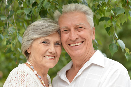 loving aged couple on a background of trees