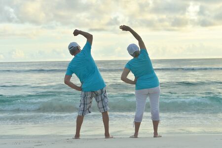 Happy Senior couple exercising in summer on  seashoreの写真素材