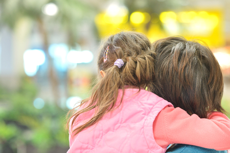 Little cute girl with mother in park, back viewの写真素材