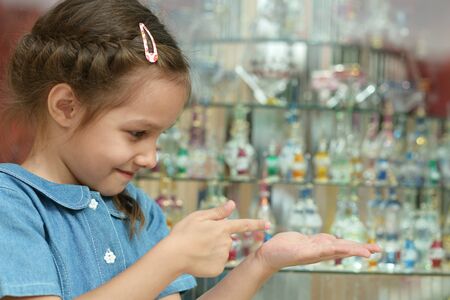 Cute little girl pointing her finger at somethingの写真素材