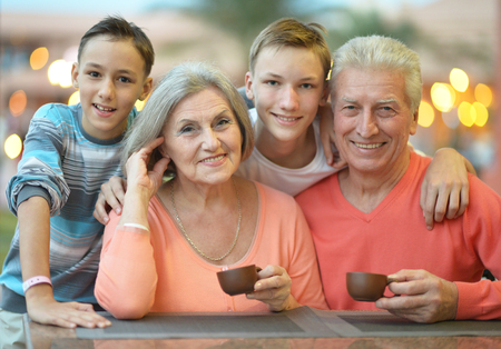 Happy family at breakfast on tropical resortの写真素材