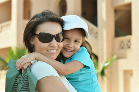 Happy mother with her daughter walk in summer parkの写真素材