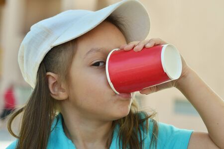 Portrait of a cute Little girl drinkingの写真素材