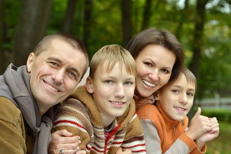 Portrait of family relaxing in autumn parkの写真素材