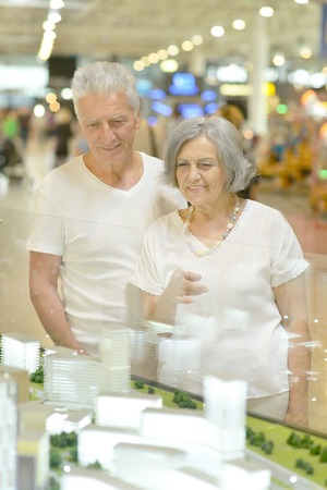 Portrait of beautiful elderly couple in shopping mallの写真素材