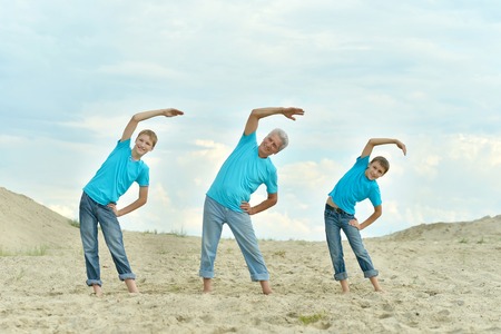 elderly man with grandson charge on the beachの写真素材