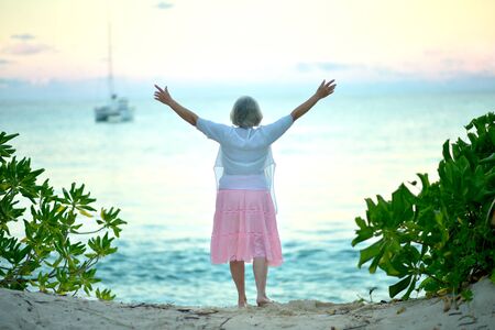 Portrait of a happy elderly woman on beach